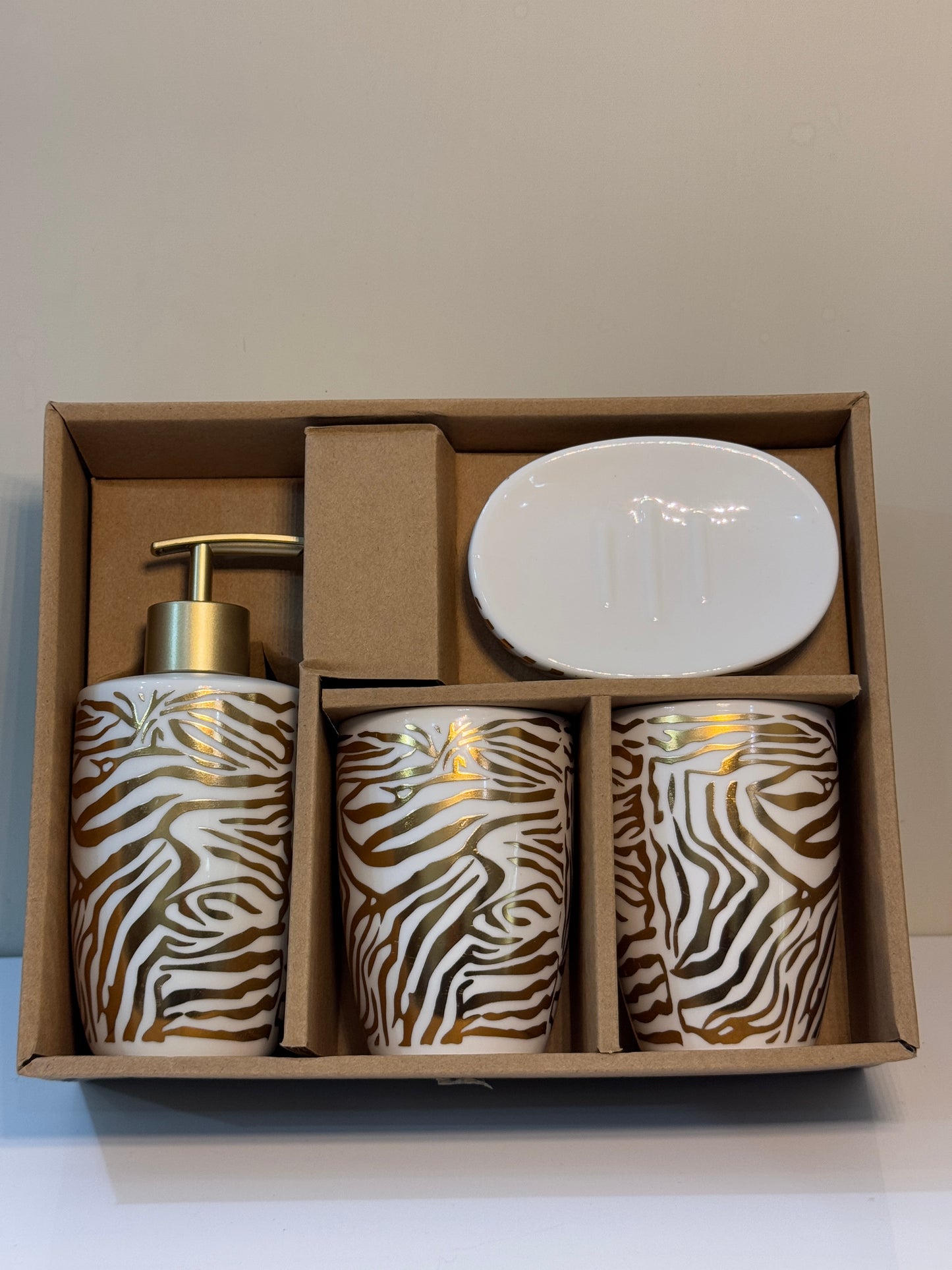 4-piece tiger print ceramic bathroom set securely packaged, showcasing the glossy finish and unique design.