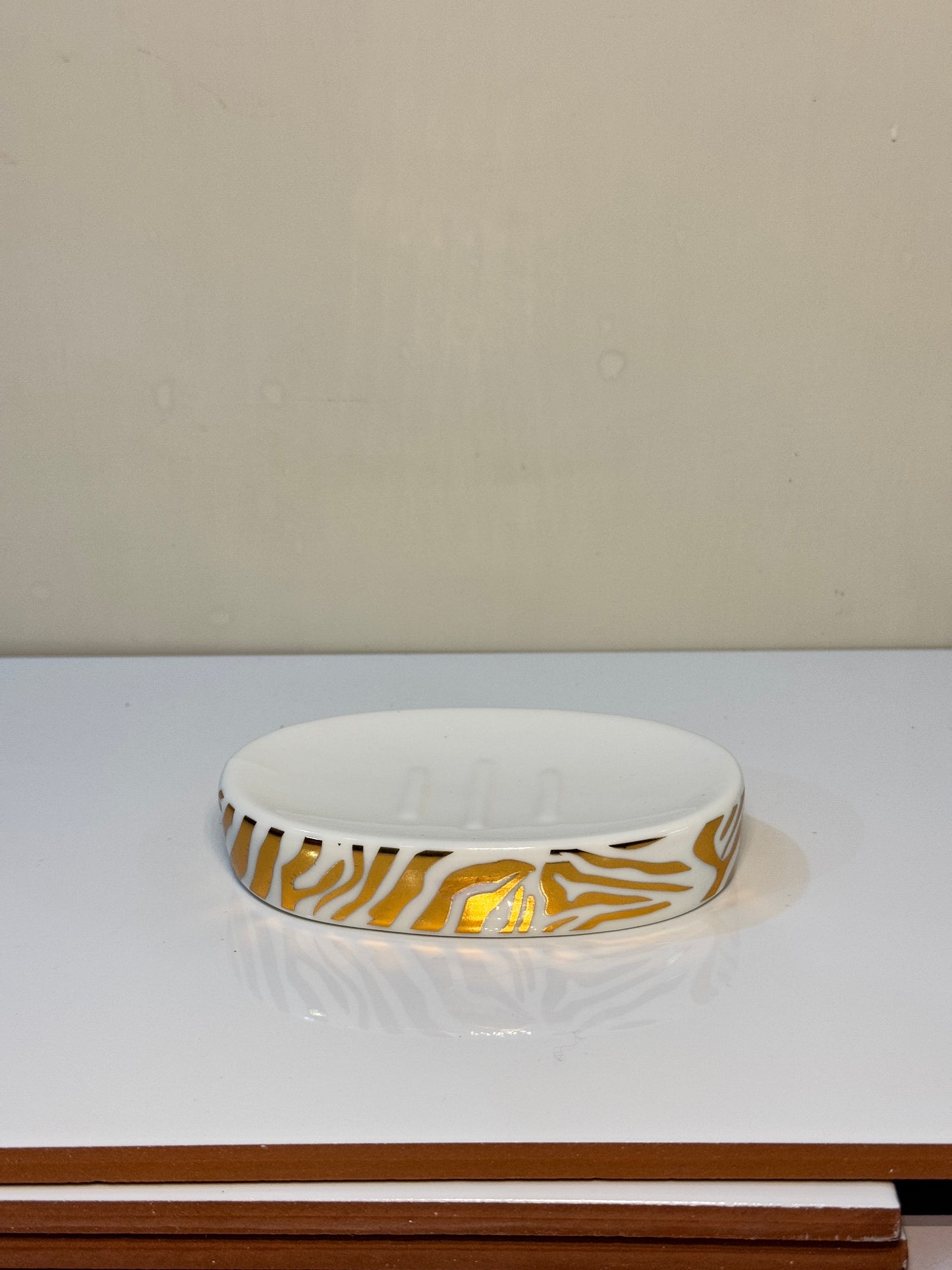 Ceramic soap dish with a tiger print design, ideal for keeping soap dry and clean.