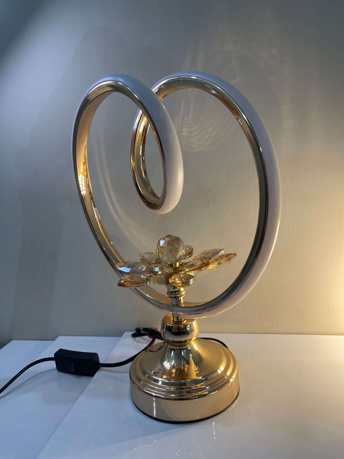 Circle lamp with flower base lit up, providing a soft, warm glow.