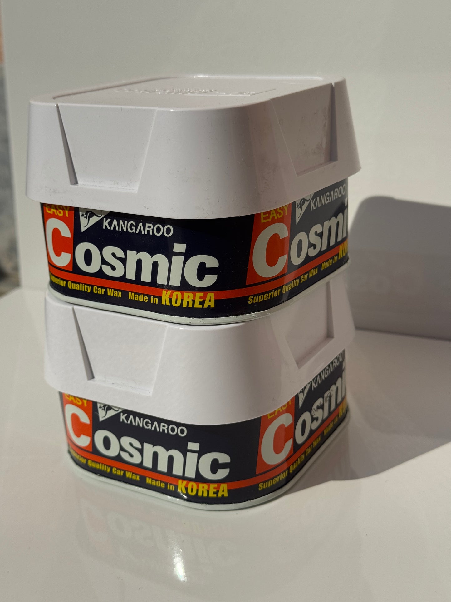 Close-up of kangaroo cosmic wax forming a glossy wax film on a car's metal surface.