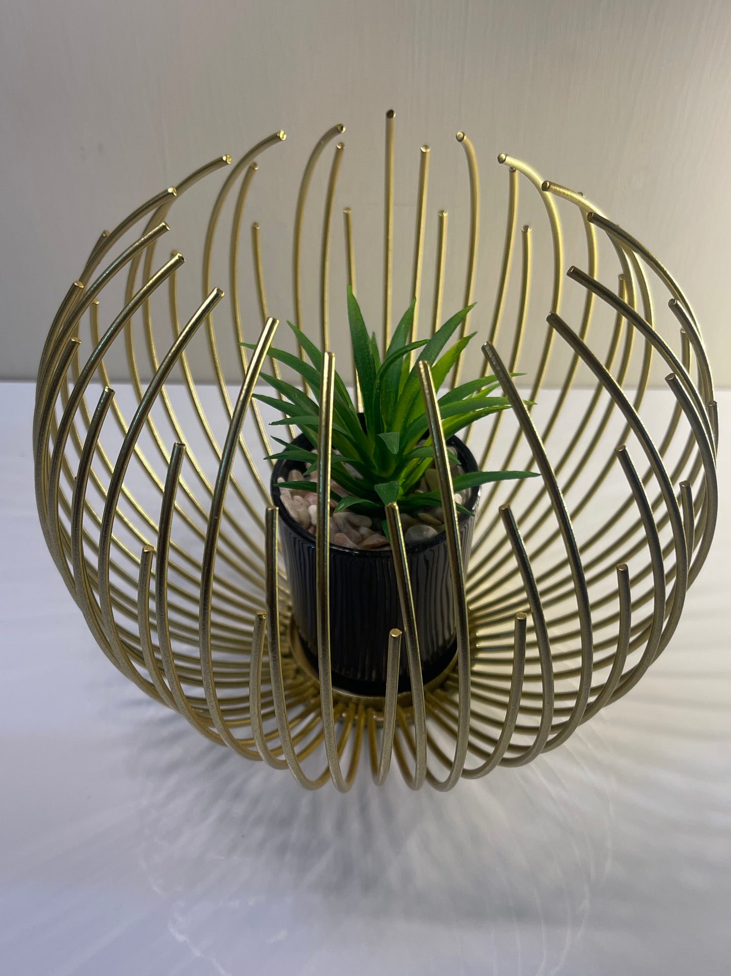 Close-up of the metallic golden globe with removable planter insert.