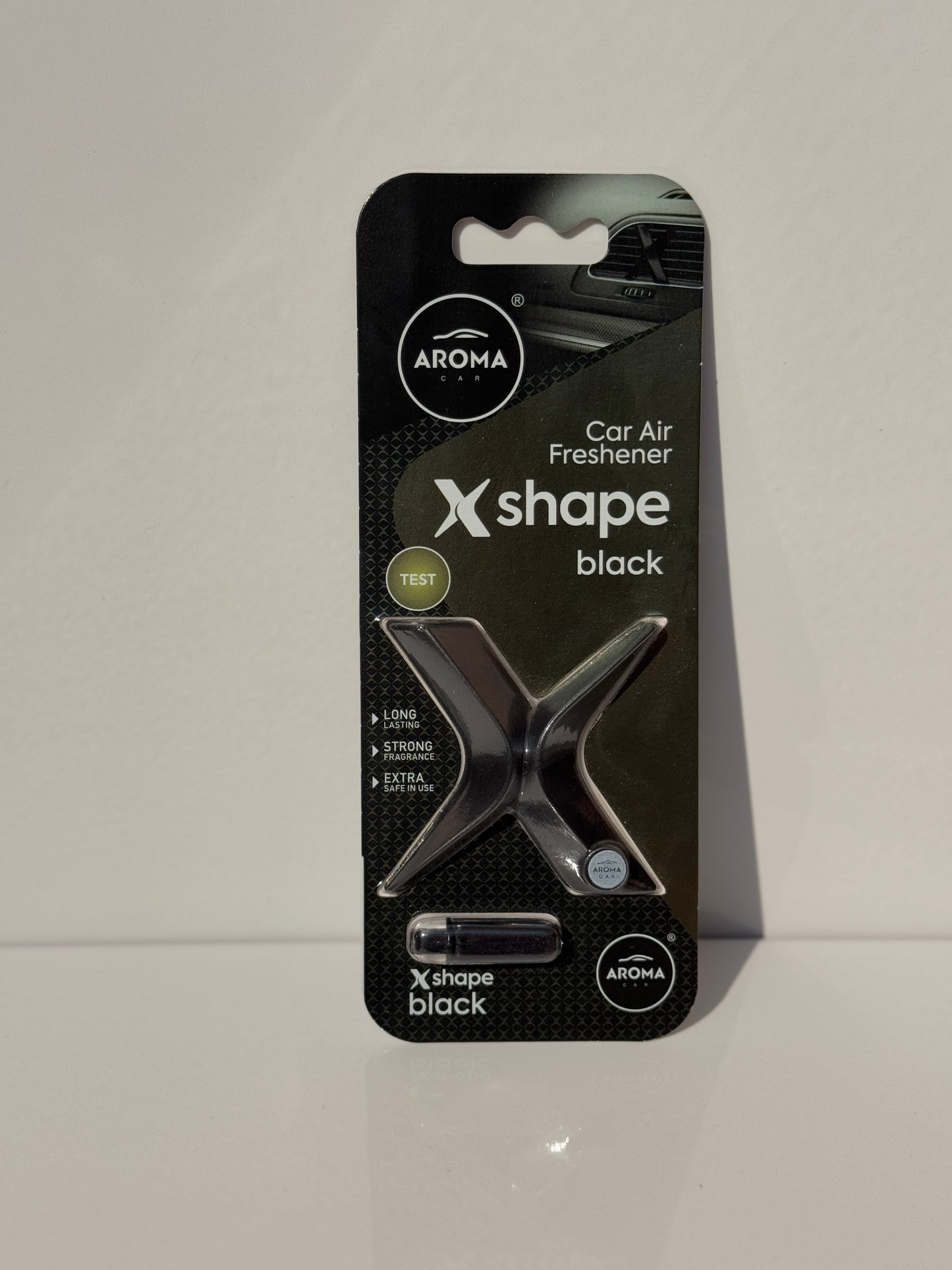 Close-up of the minimalist X-shape design air freshener for cars from Aroma.