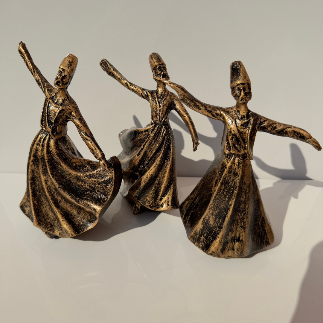 Close-up of the twirling dervish statue showcasing intricate brass detailing.