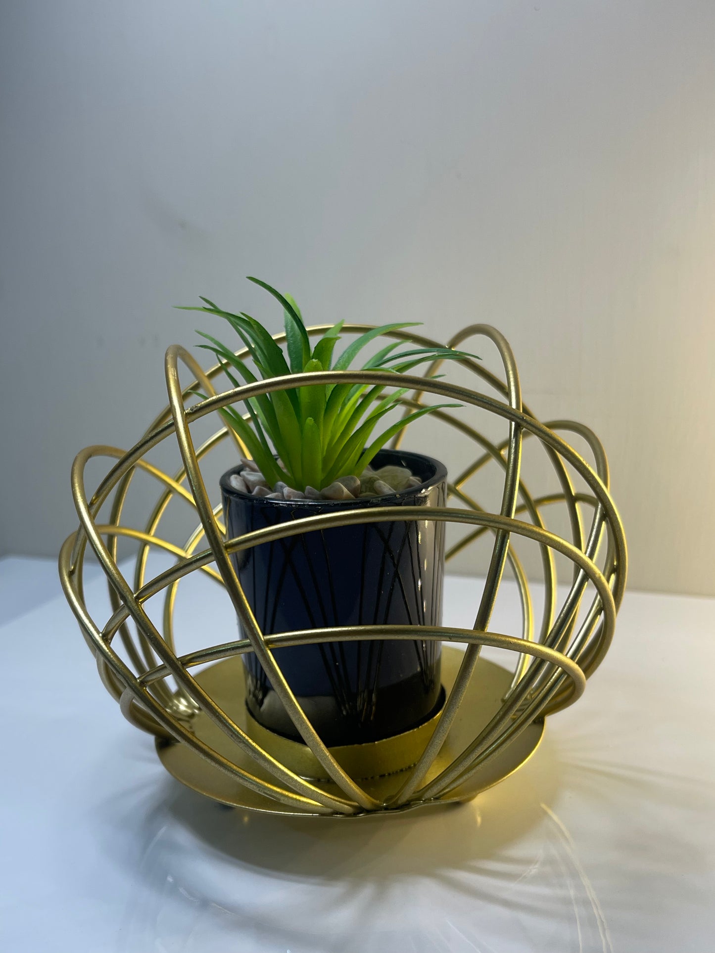 Decorative metal cactus pot stand displayed on a desk, adding charm and personality to the space.