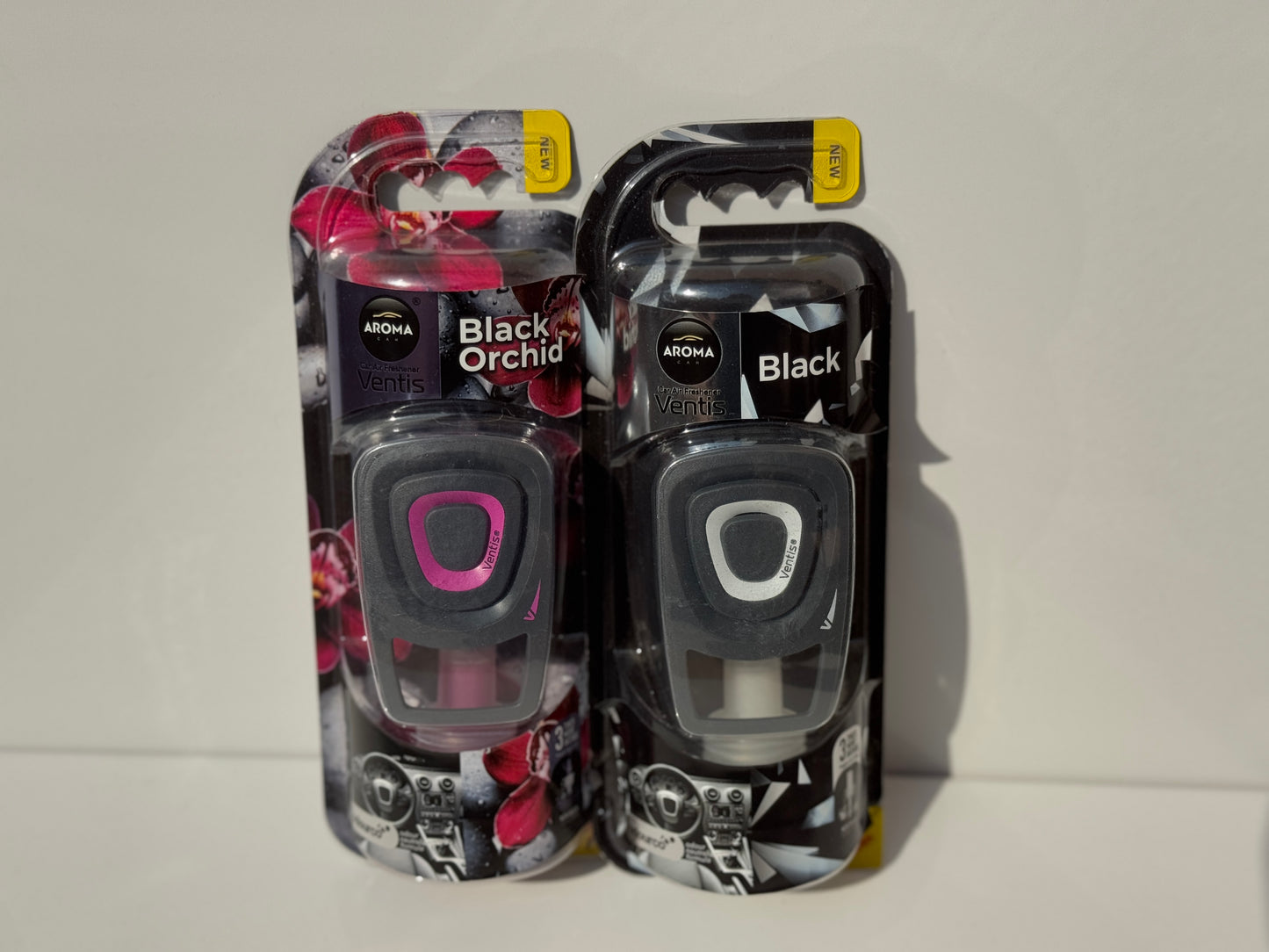 Dual display of Aroma Ventis Air Fresheners in 'Black Orchid' and 'Black,' perfect for various preferences.