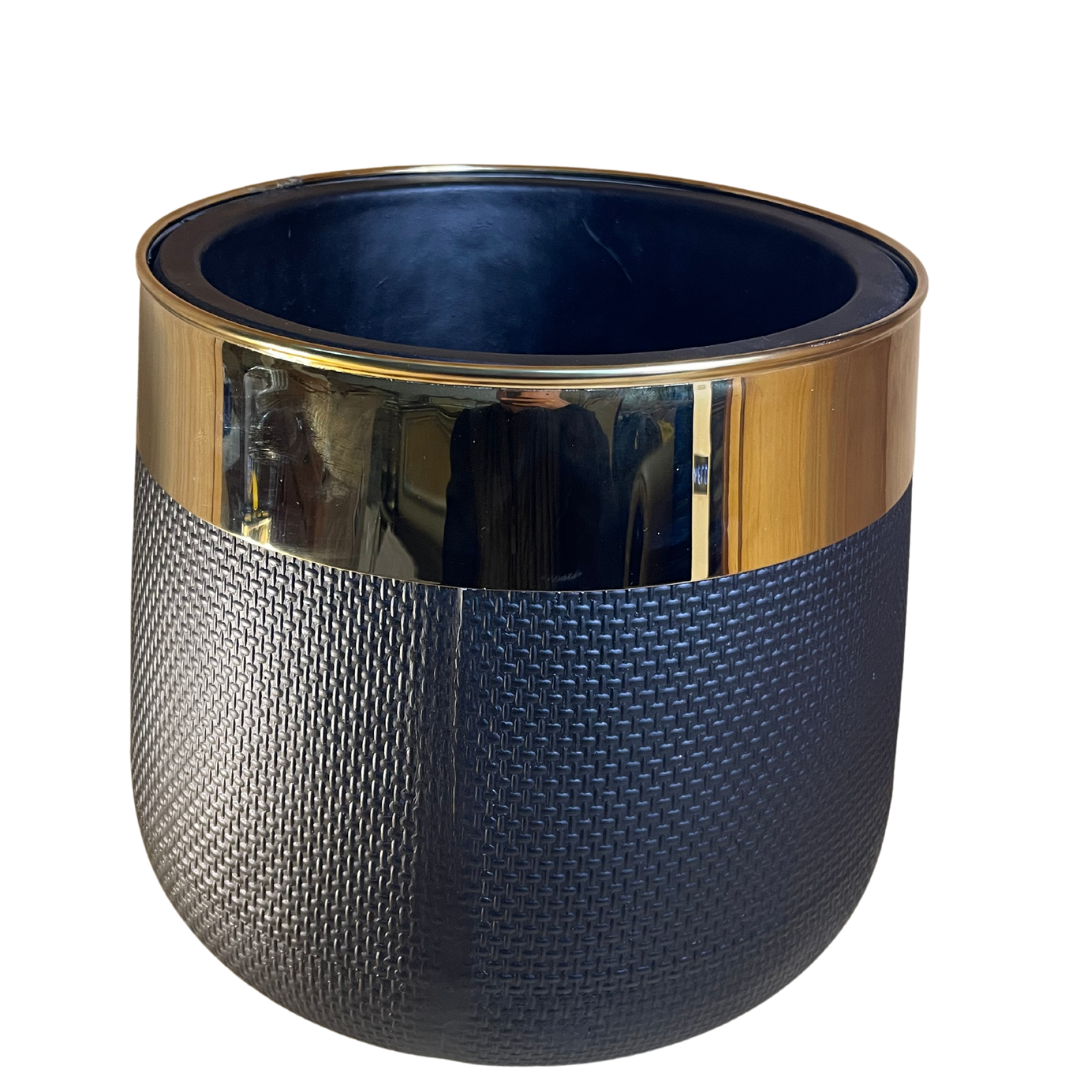 Elegant black fiber flower pot showcasing lush green foliage in a minimalist setting.