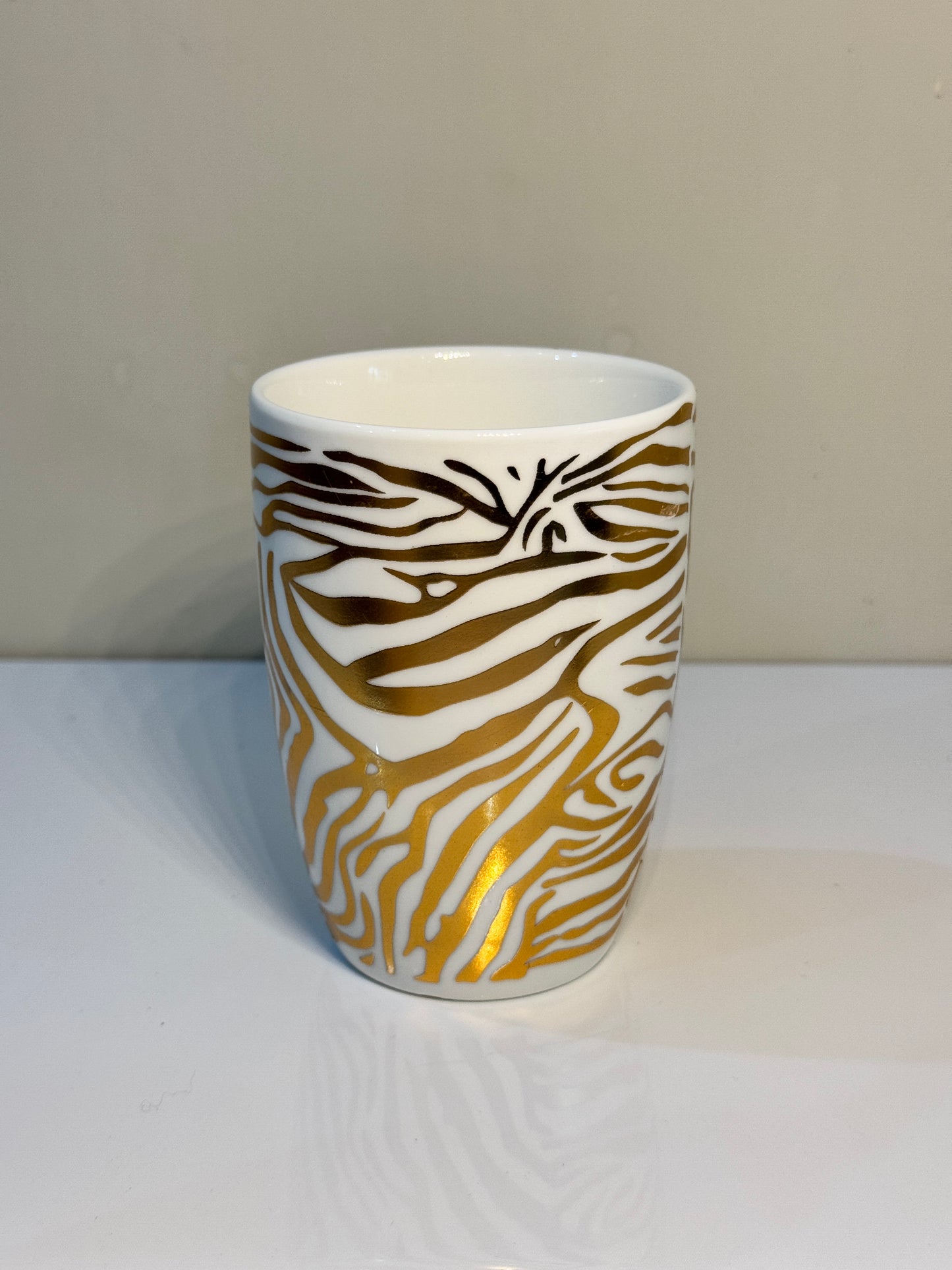 Glossy black ceramic tumbler with a tiger print design, perfect for bathroom essentials.