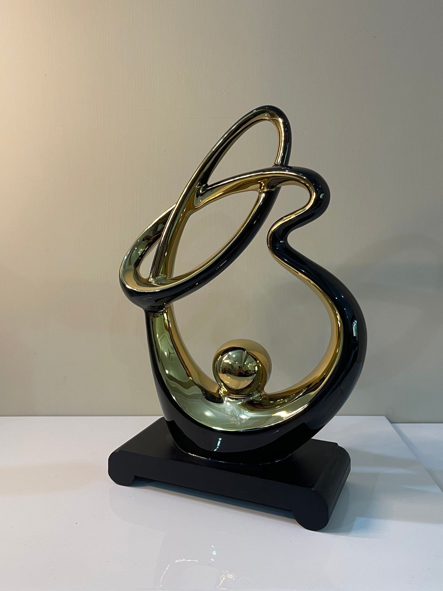 Luxury abstract resin sculpture featuring gold inner accents and a sleek black base.