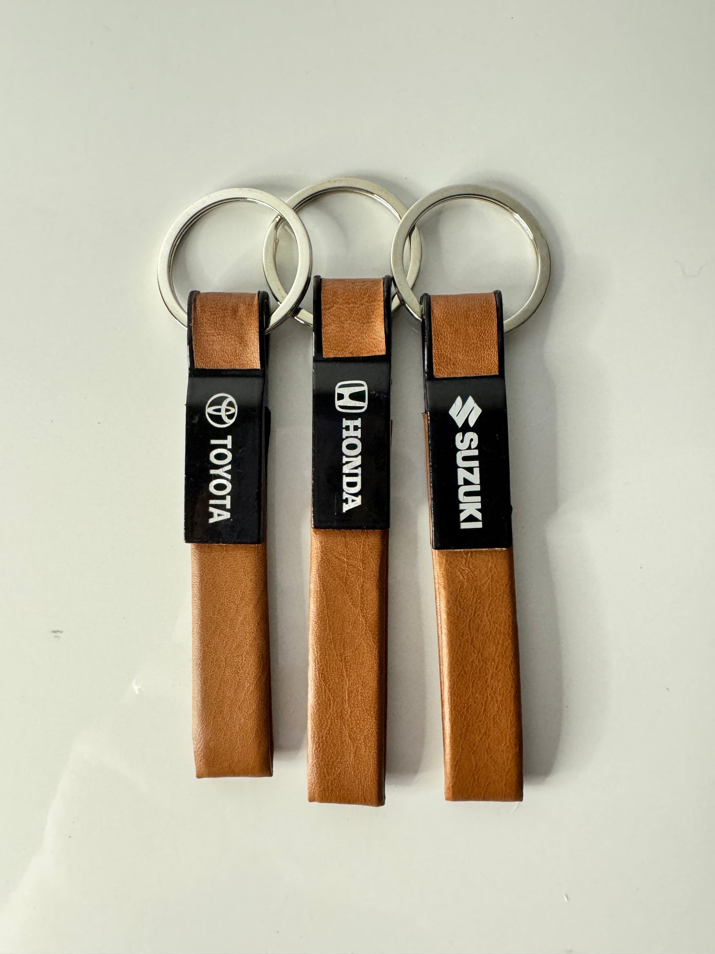 Shop premium Straight Line Metal Leather Keychains for Honda, Suzuki, and Toyota at Tech Car Home Pakistan. Durable, stylish, and perfect for car lovers.