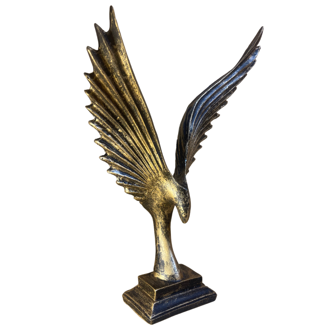 Side view of the High Flying Eagle Ornament with wings spread wide on a wooden mantelpiece.