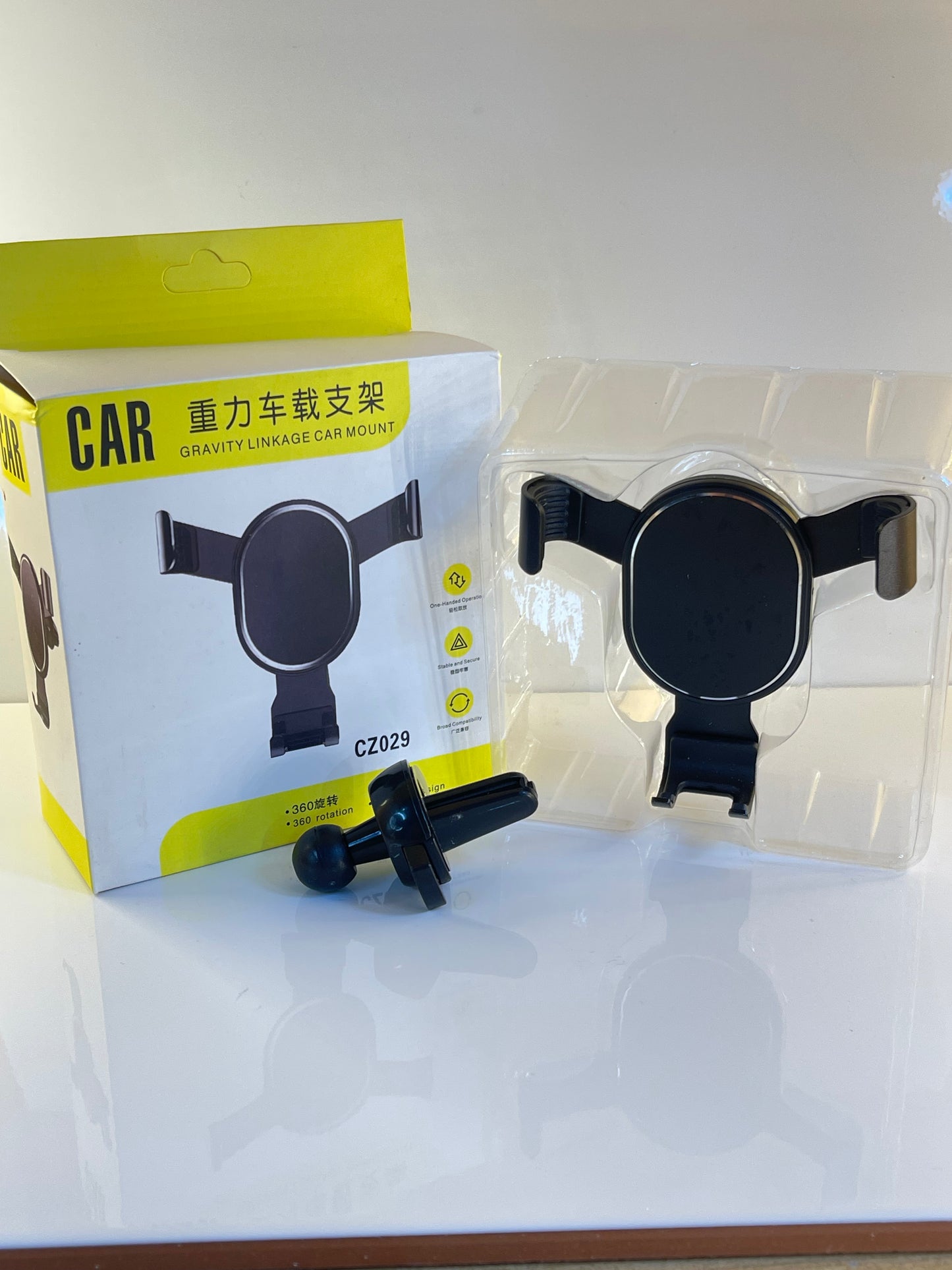 Smart Gravity Car Holder clipped onto a car air vent, holding a phone securely – by TechCarHome.com.