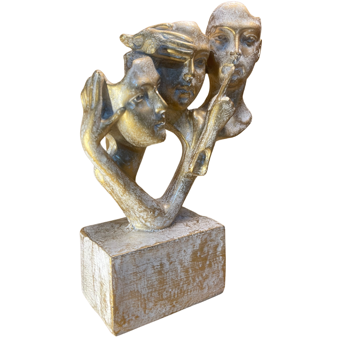 Vintage Gold Figurines displayed as a centerpiece on a modern coffee table, showcasing the 'see no evil, hear no evil, speak no evil' design.