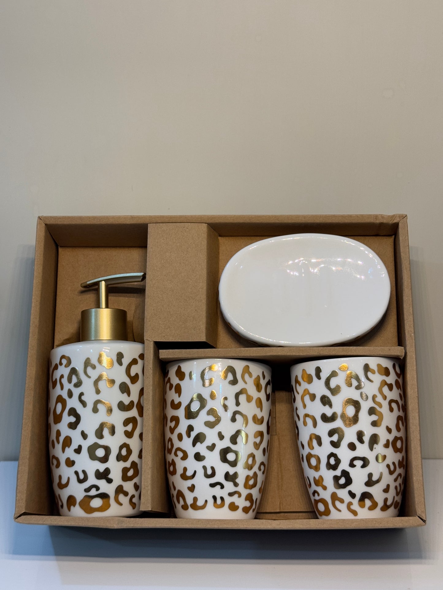 4-piece cheetah print ceramic bathroom set securely packaged, showcasing the glossy finish and gold accents.