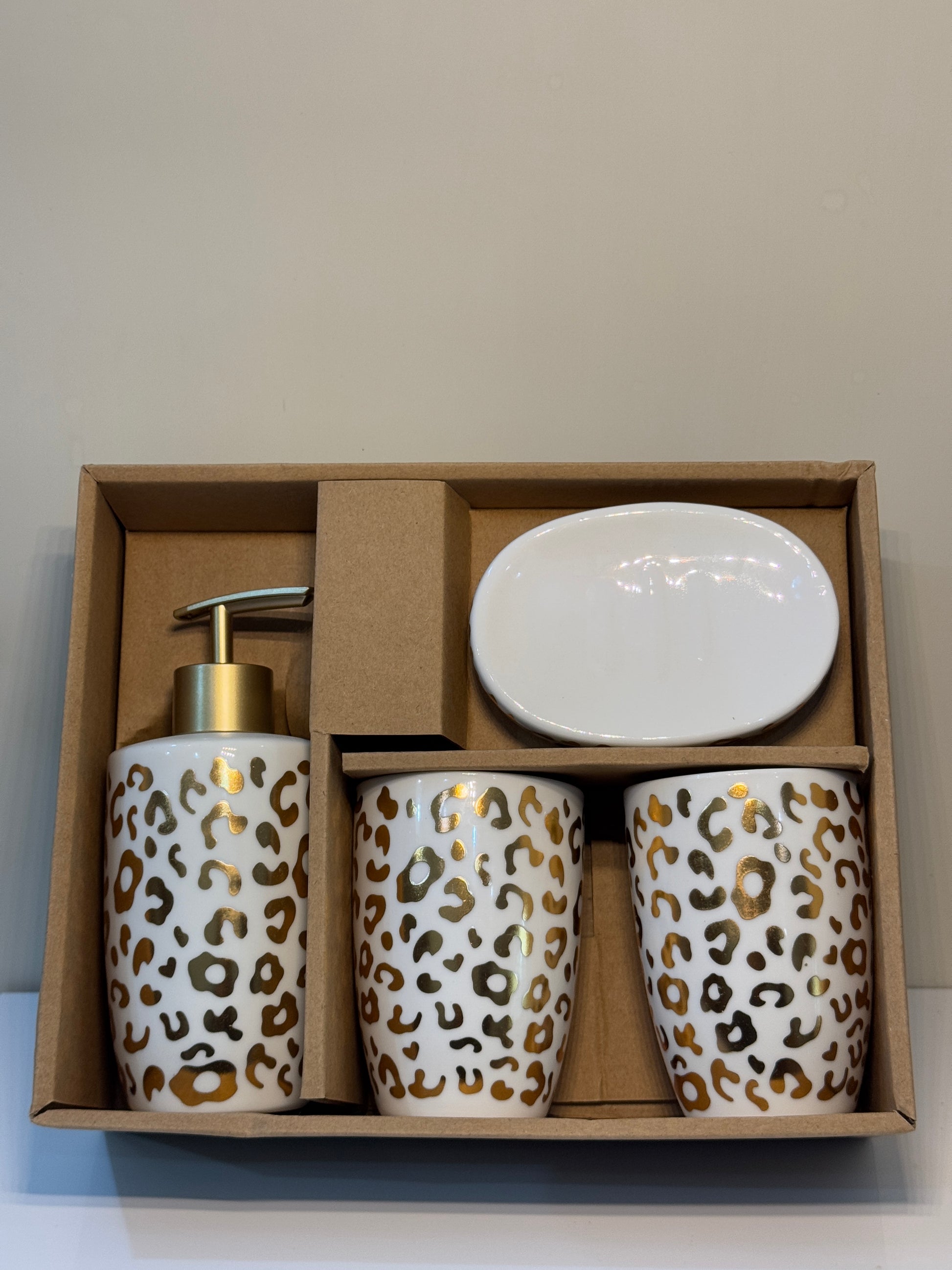 4-piece cheetah print ceramic bathroom set securely packaged, showcasing the glossy finish and gold accents.