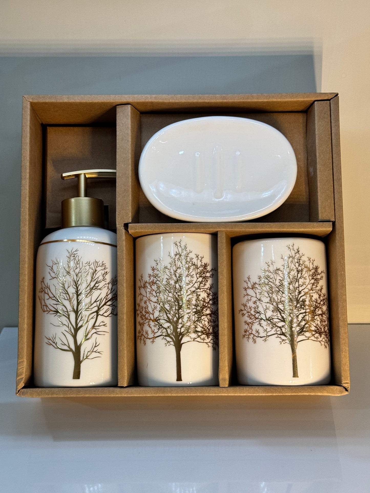 4-piece white and gold ceramic bathroom set securely packaged in a sturdy box, showcasing the round and elegant design.