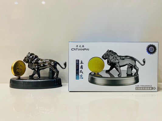 Car fragrance with lion design next to its packaging on a white surface