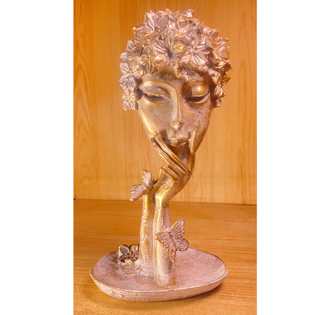 Abstract Women Face Art Sculpture displayed as a centerpiece on a modern white dining table during a Christmas dinner.