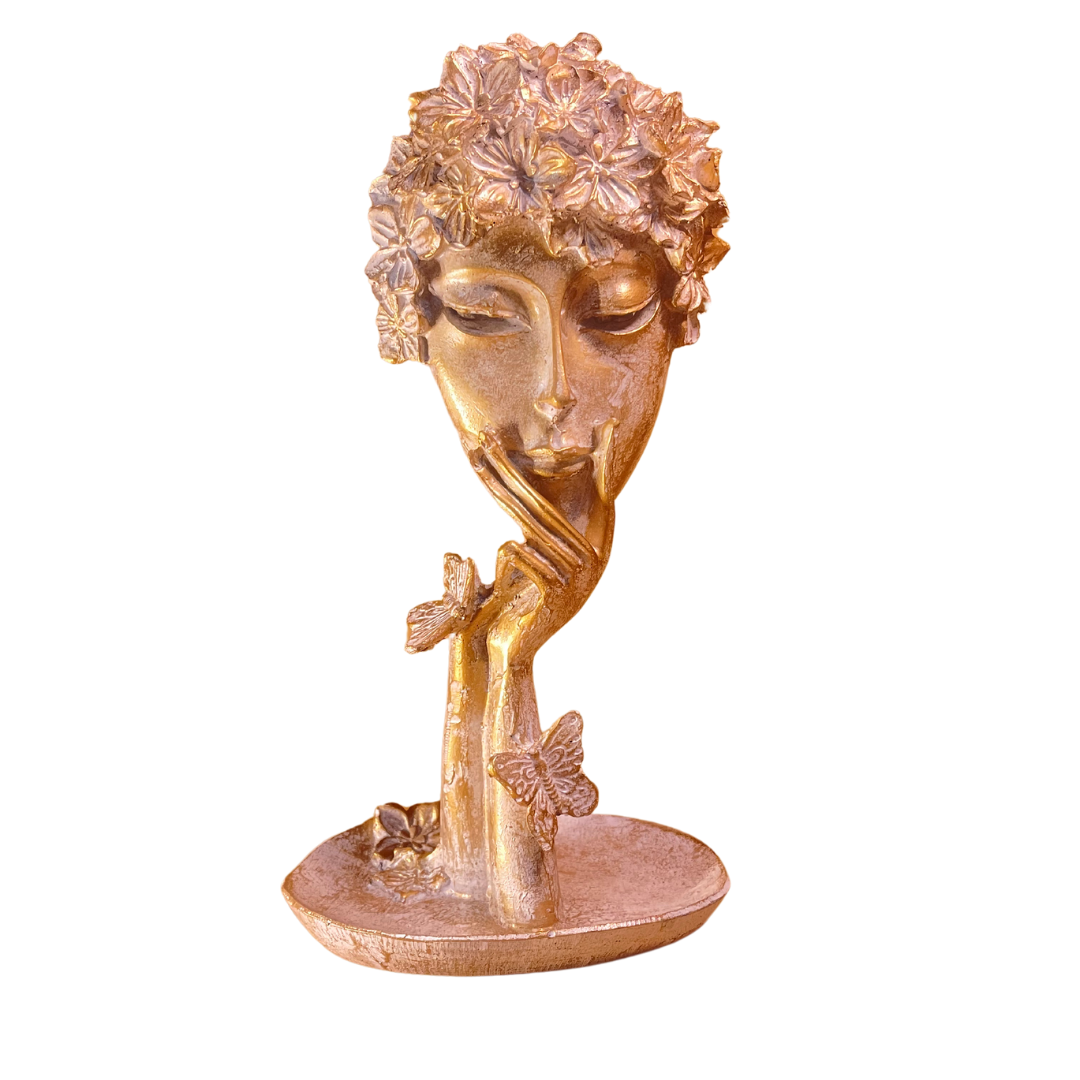 Abstract Women Face Art Sculpture elegantly styled as a wedding table centerpiece with flowers and candles.