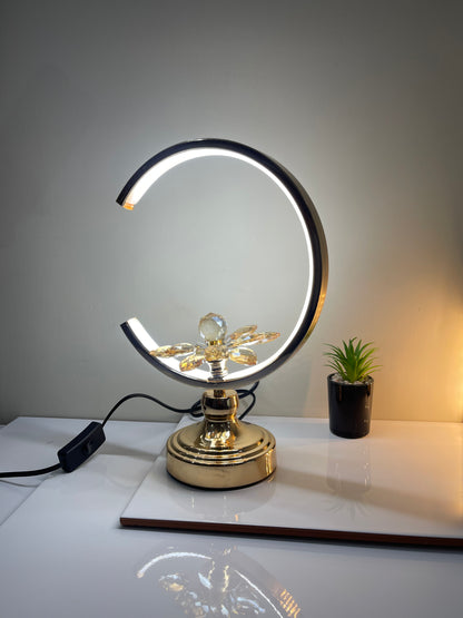 Adjustable Floral Crescent Lamp placed in a modern living room, adding elegance and ambiance to the decor.