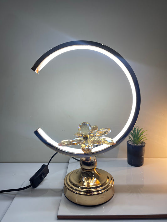 Adjustable Floral Crescent Lamp with crescent-shaped base and central flower, offering customizable lighting