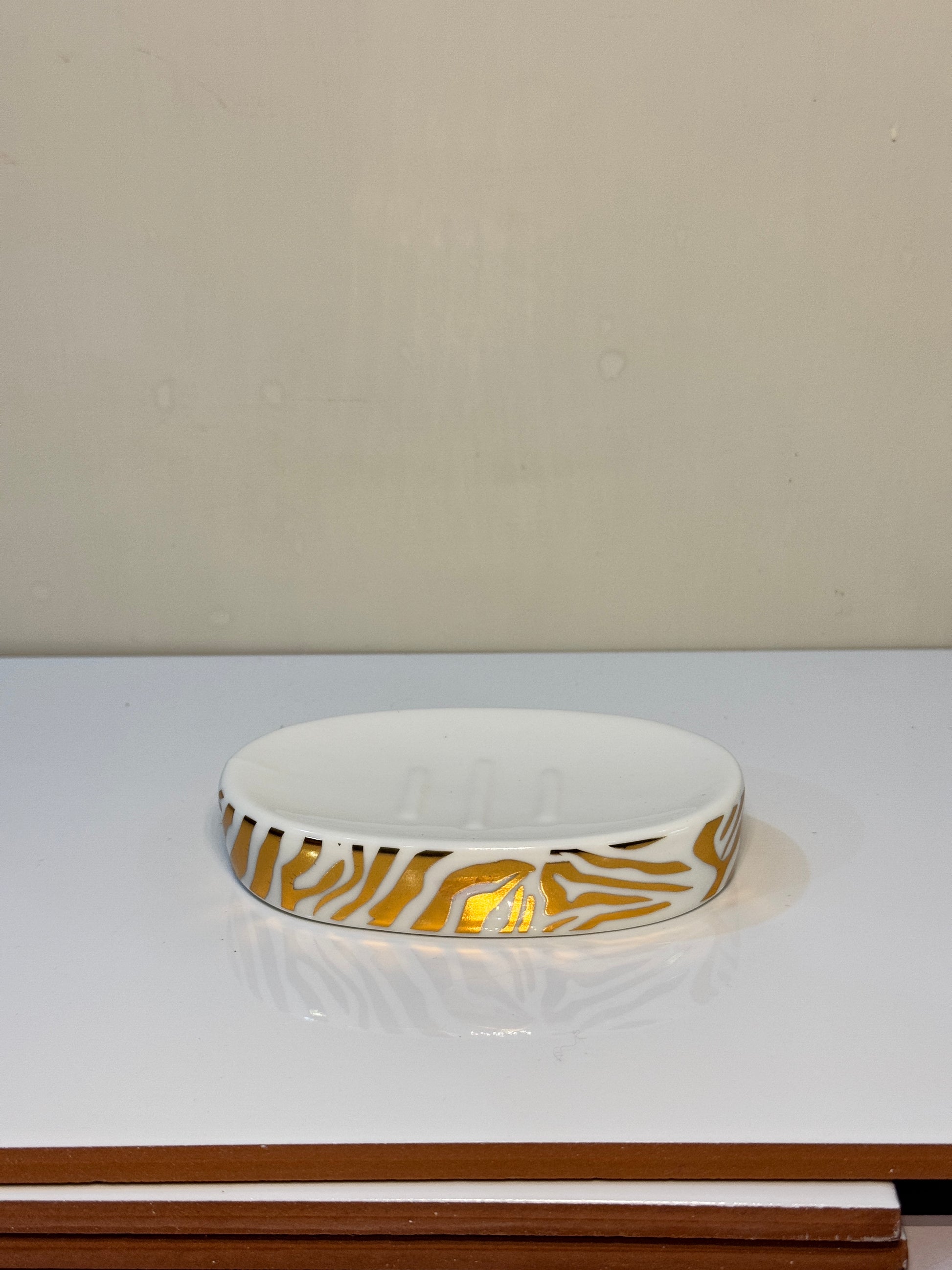Ceramic soap dish with a tiger print design, ideal for keeping soap dry and clean.