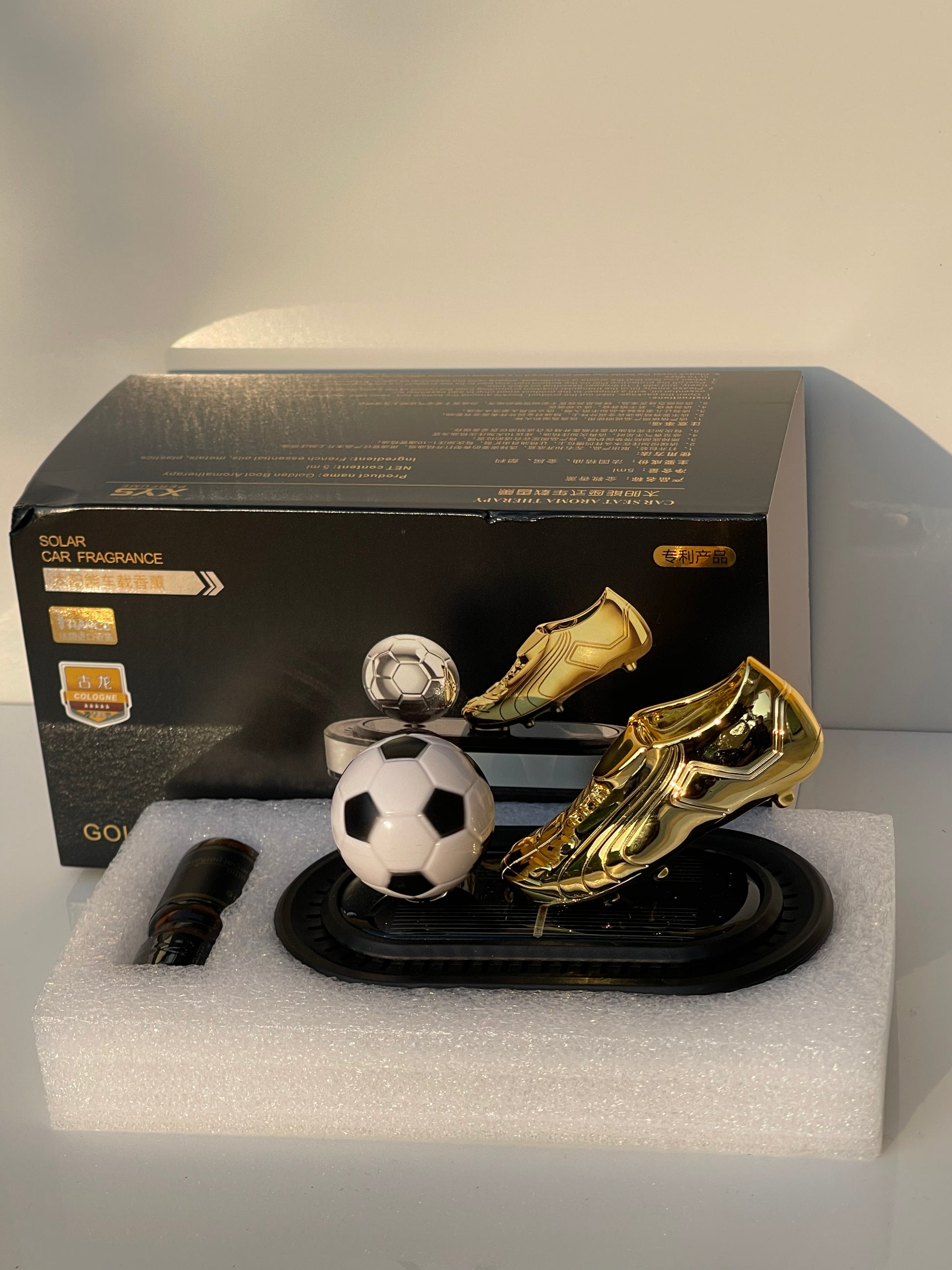 Close-up of Solar Powered Rotating Football Car Perfume
