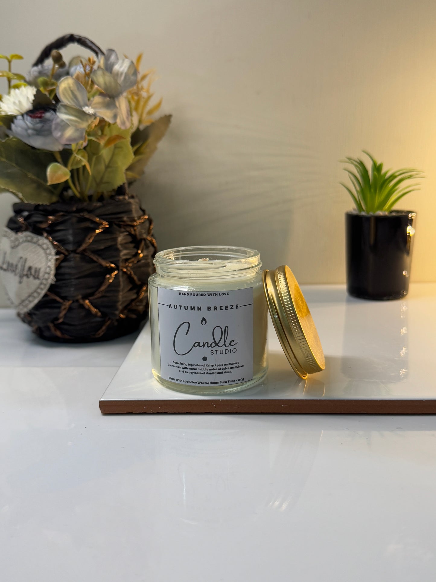 Close-up of the Autumn Breeze candle jar, highlighting its smooth finish and rich, fall-inspired wax.