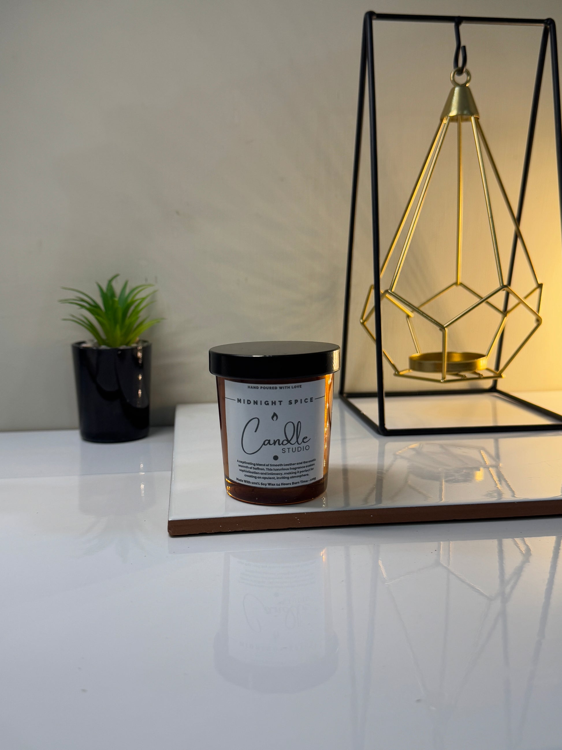 Close-up of the Midnight Spice candle jar, highlighting its smooth texture and deep, inviting color.