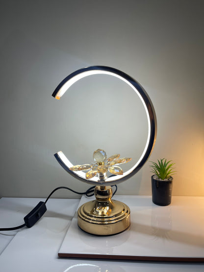 Close-up of the central flower at the base of the Adjustable Floral Crescent Lamp, showcasing its intricate design.