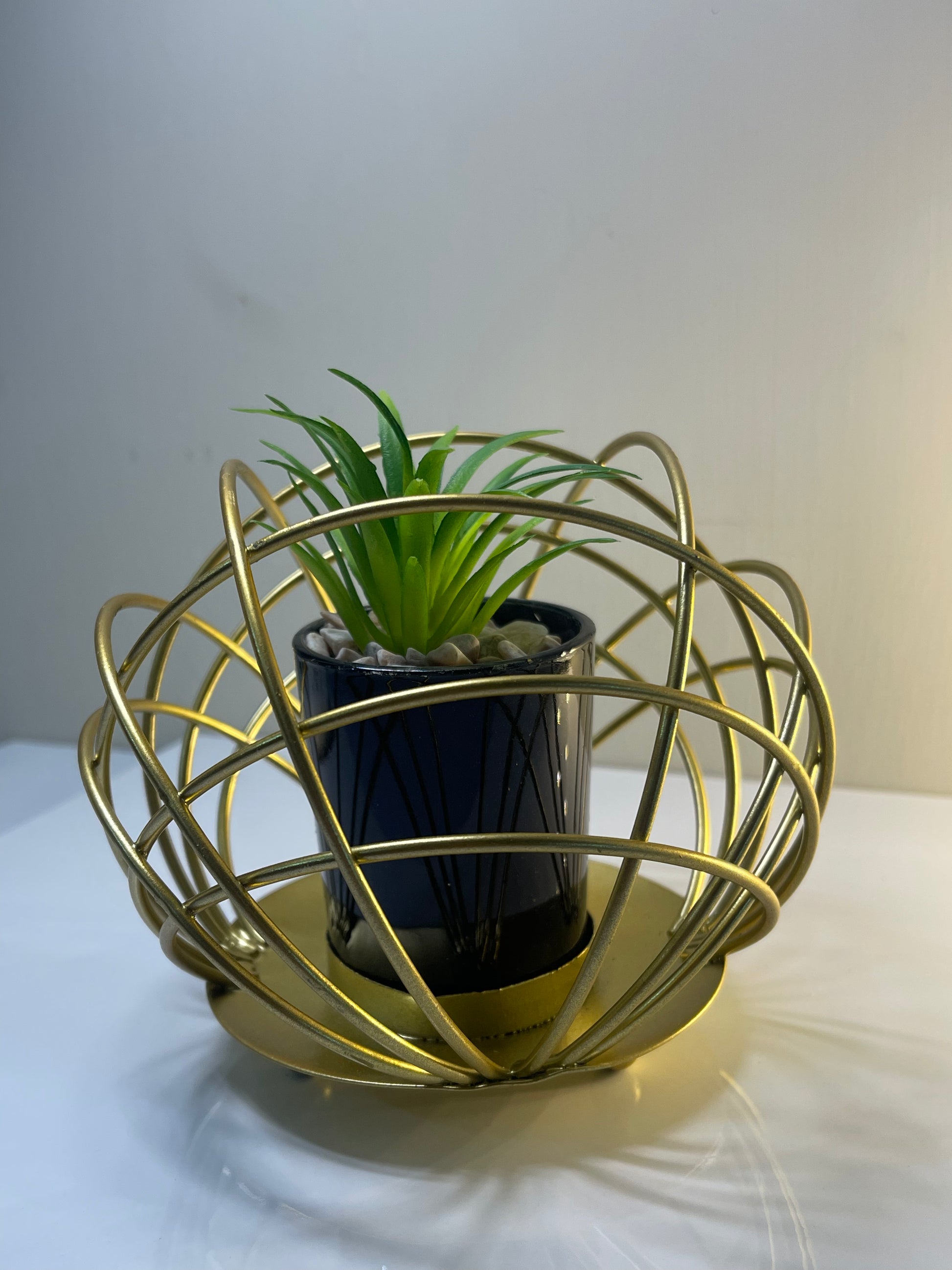 Decorative metal cactus pot stand displayed on a desk, adding charm and personality to the space.