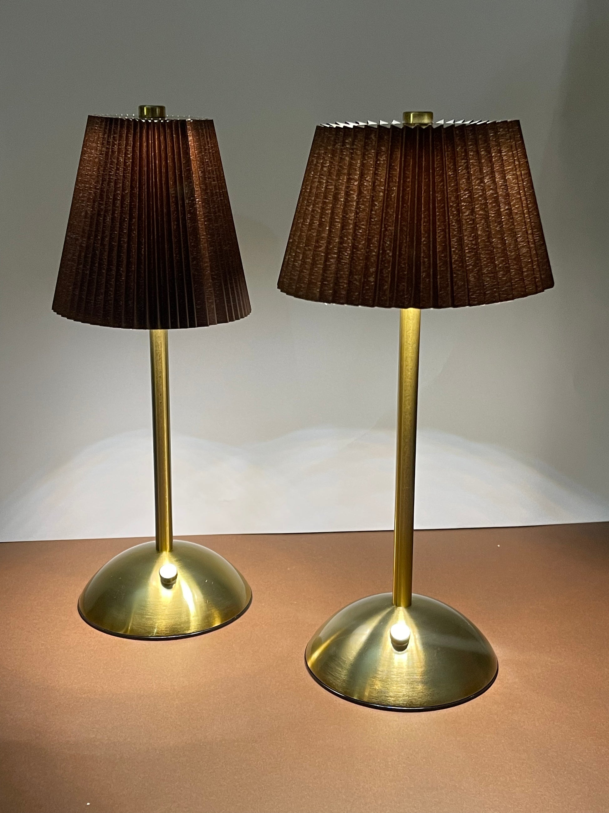 Elegant bedside lamp with a gold metallic base and fabric lampshade.