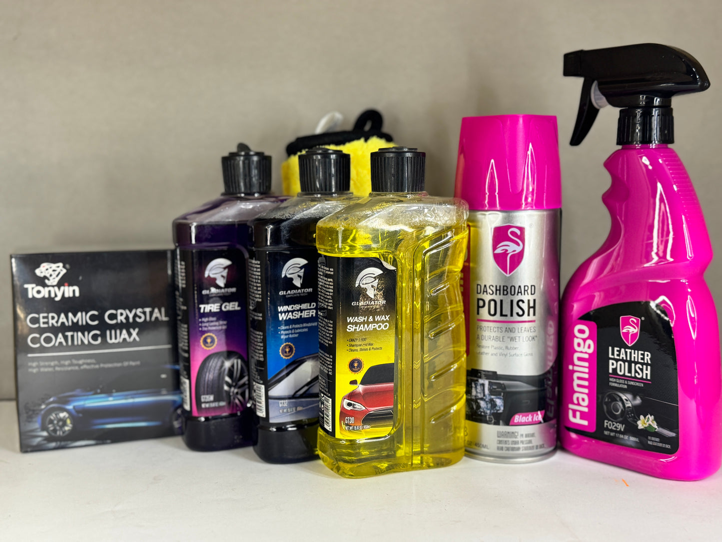 Flamingo Dashboard and Leather Polish sprays placed on a car dashboard and leather seat.