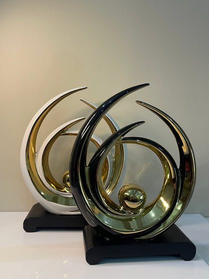 Gold-accented layered circle ornament with a black base and white outline, featuring overlapping circular designs.