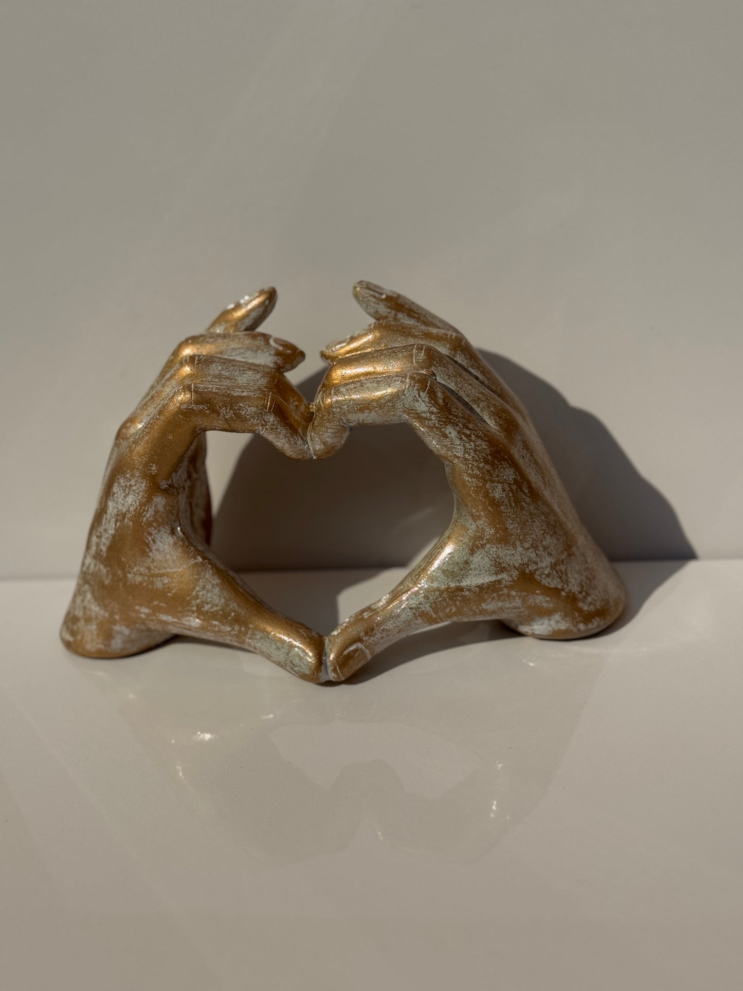 Gold Love Sign Figure showcasing modern hand gesture heart decor.