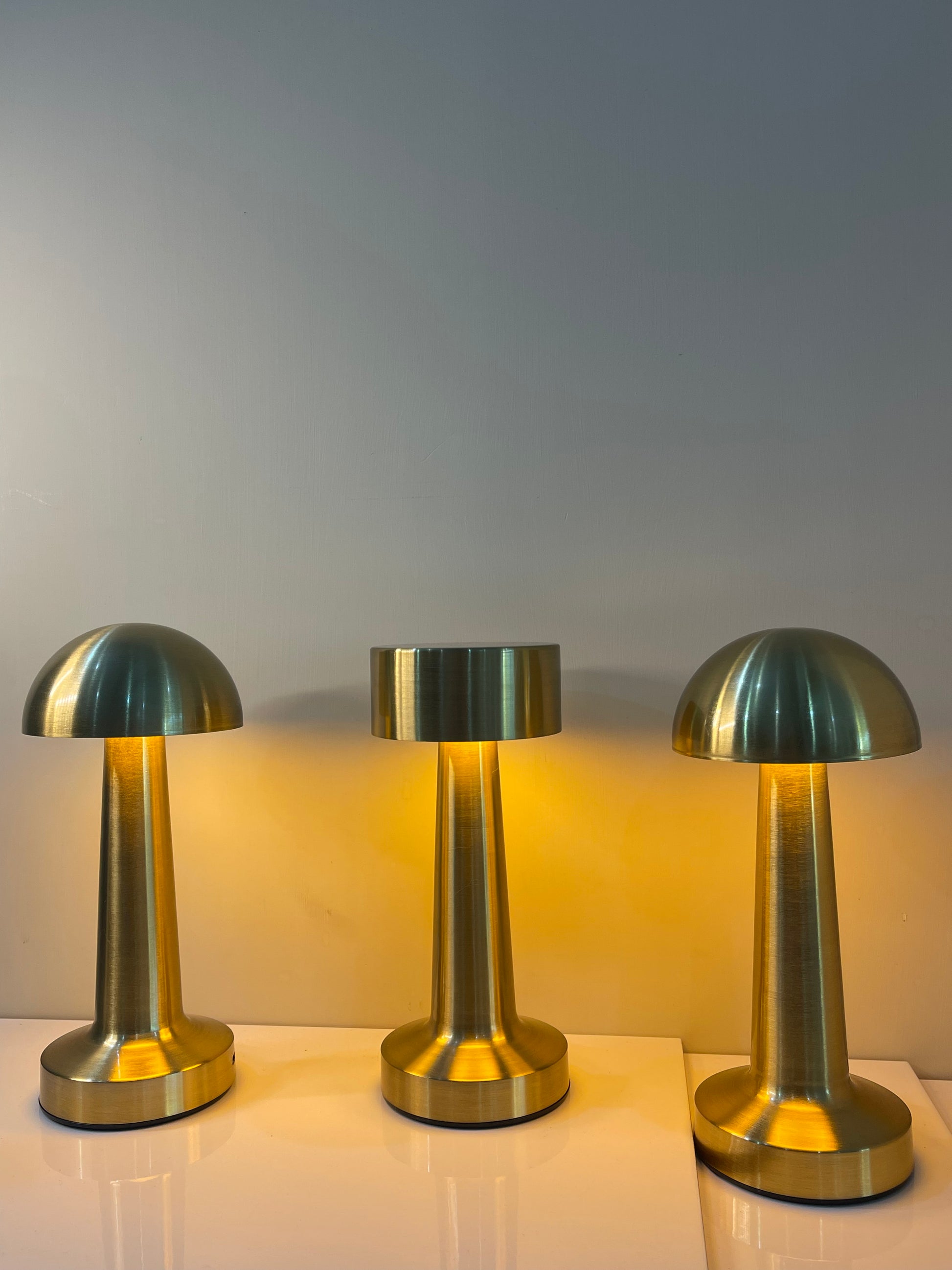 Gold touch-controlled lamp with a sleek dome-shaped top, perfect for modern bedside or table décor.