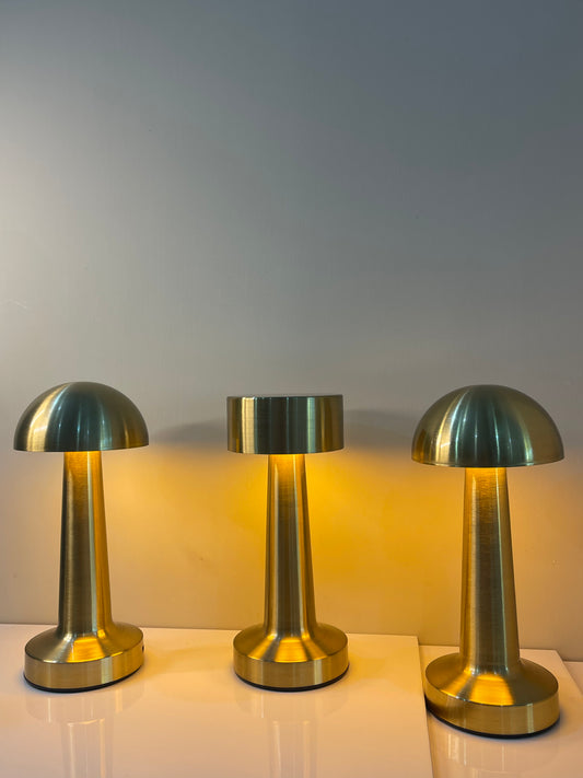 Gold touch-controlled lamp with a sleek dome-shaped top, perfect for modern bedside or table décor.