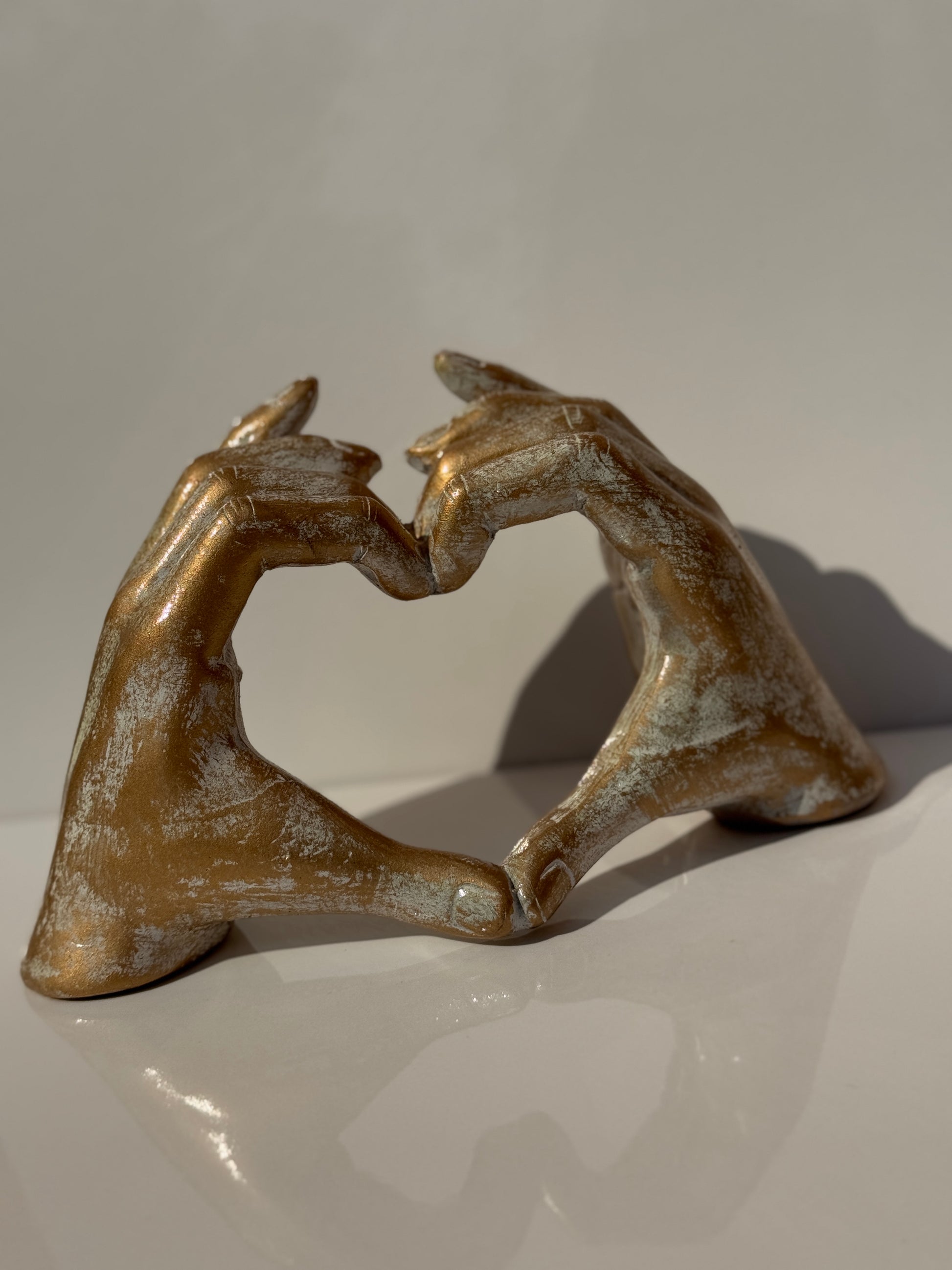 Hip Hand Gesture Heart Icon Figure in gold, perfect for contemporary home decor.
