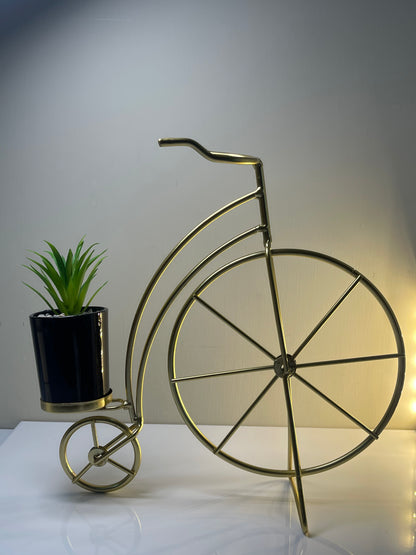 Metallic golden cycle planter with a sleek glossy finish.