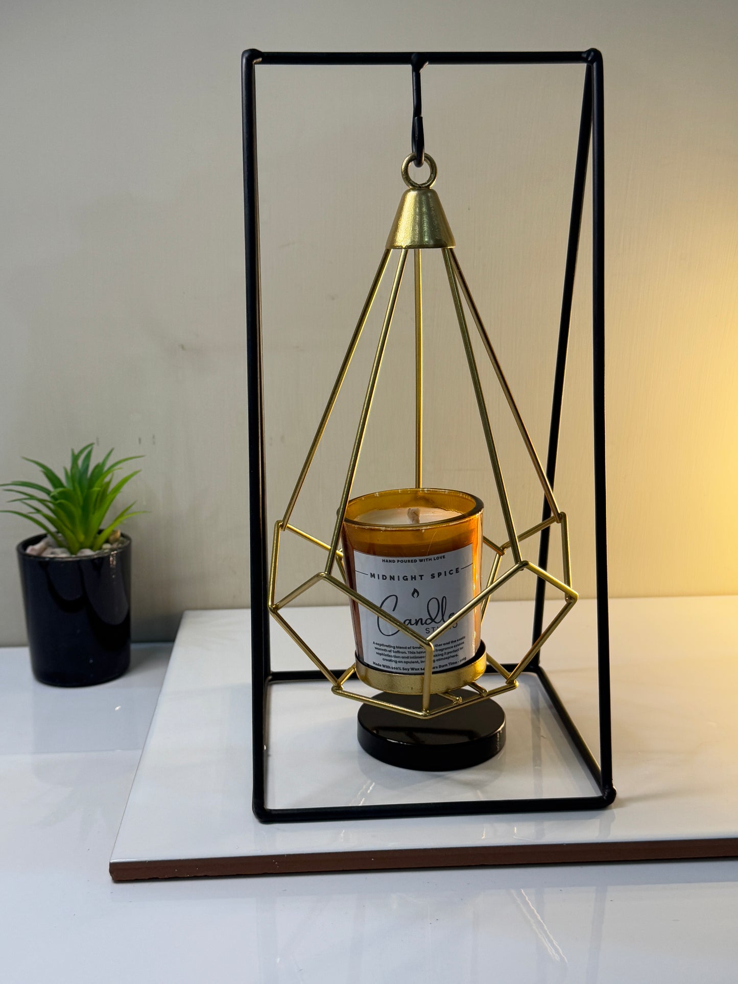 Midnight Spice candle in its jar, styled on a tabletop to add a touch of sophistication and warmth to the decor.