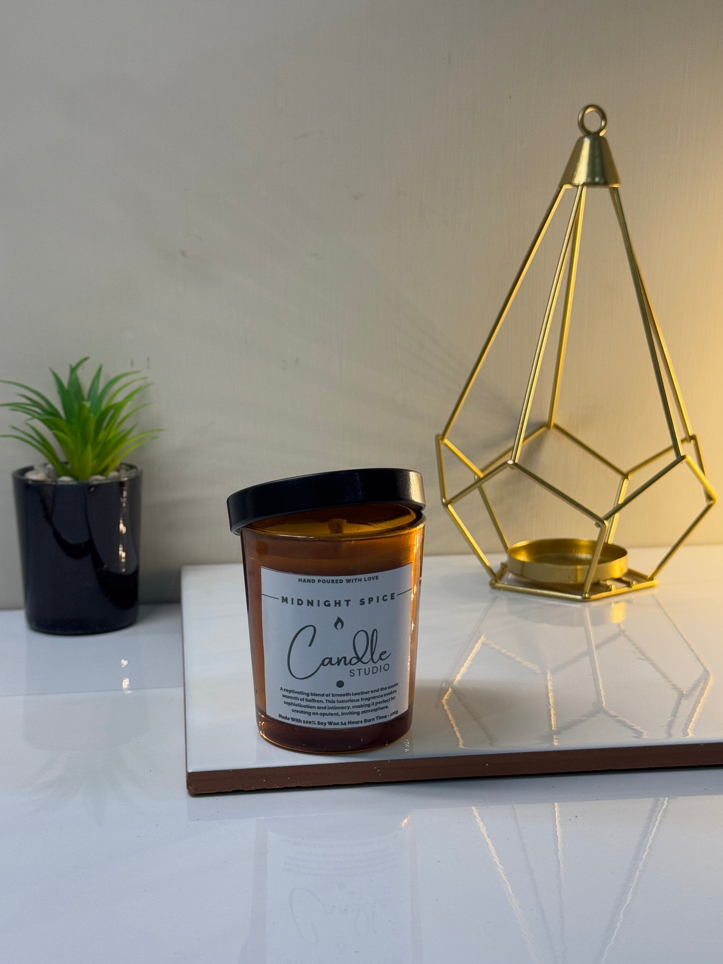 Midnight Spice candle placed in its glass jar, waiting to fill the room with its warm and spicy fragrance when lit.