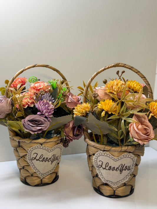Mini flower basket featuring a variety of vibrant artificial flowers arranged in a small round-shaped woven basket.