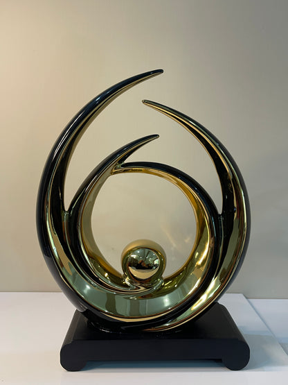 Modern luxury ornament with gold accents, a white outline, and a black base, perfect for home décor.