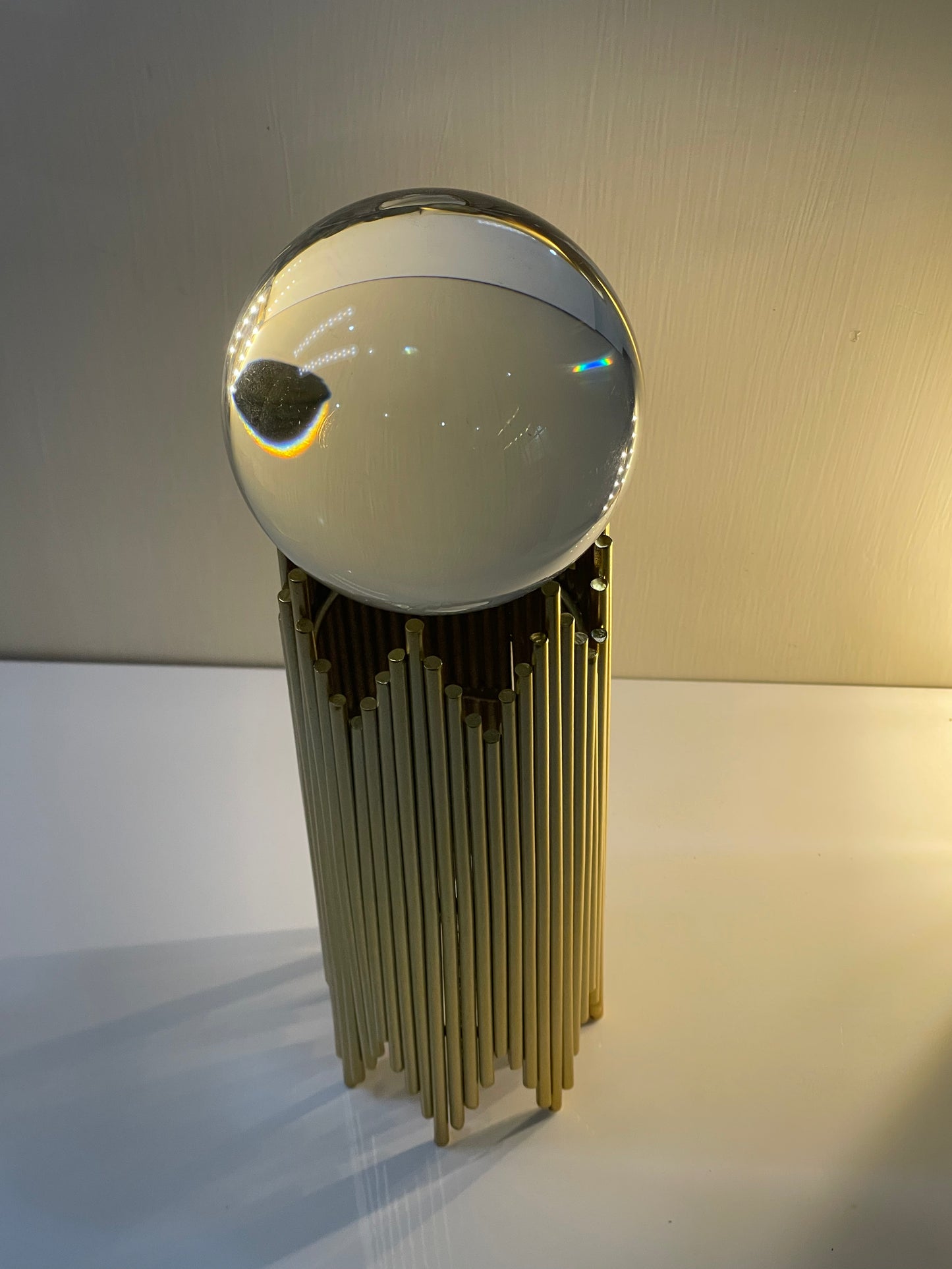 Nordic crystal ball display stand placed on a desk with modern decor accents.