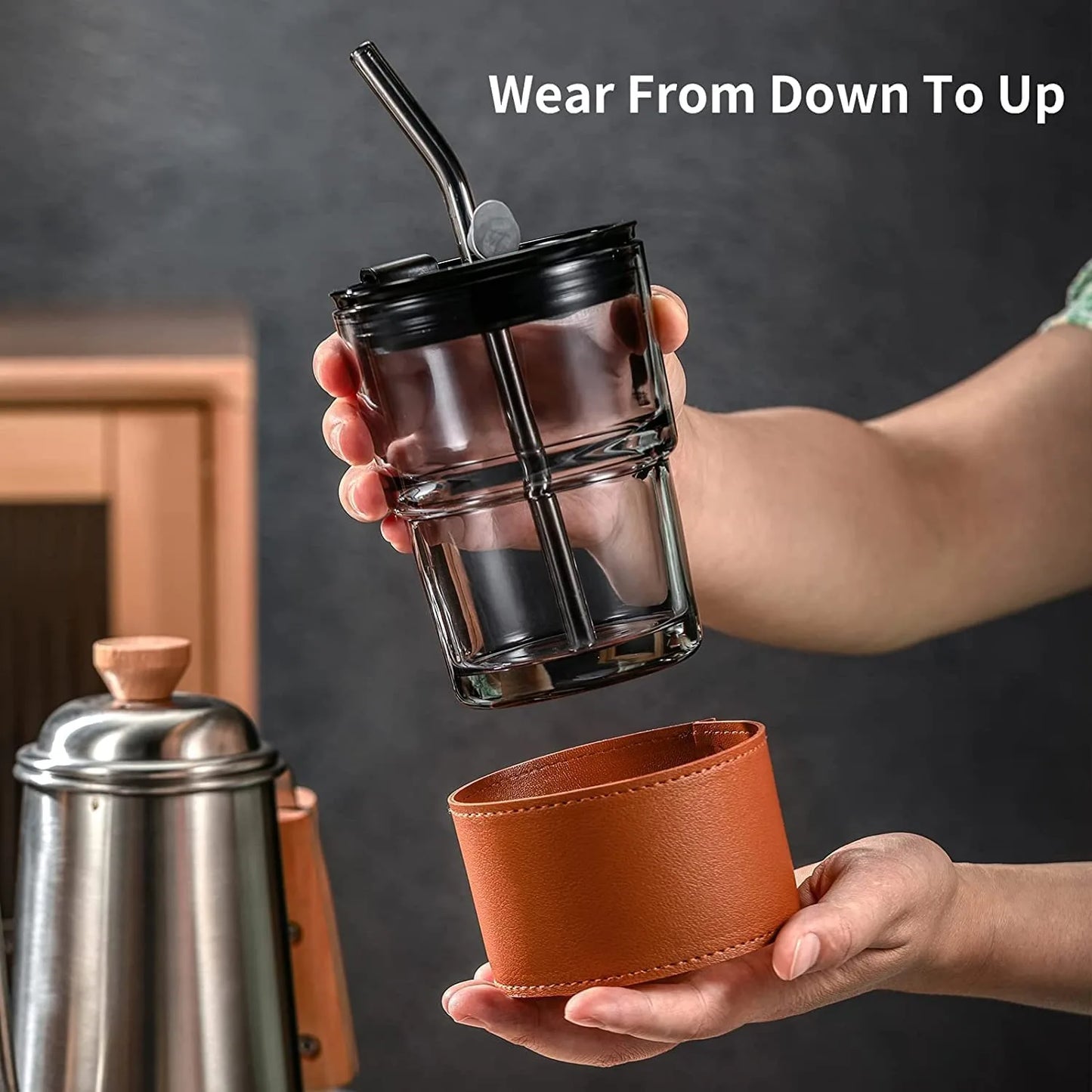 Person holding the Leather Covered Glass Cup, showing comfort and a stylish grip