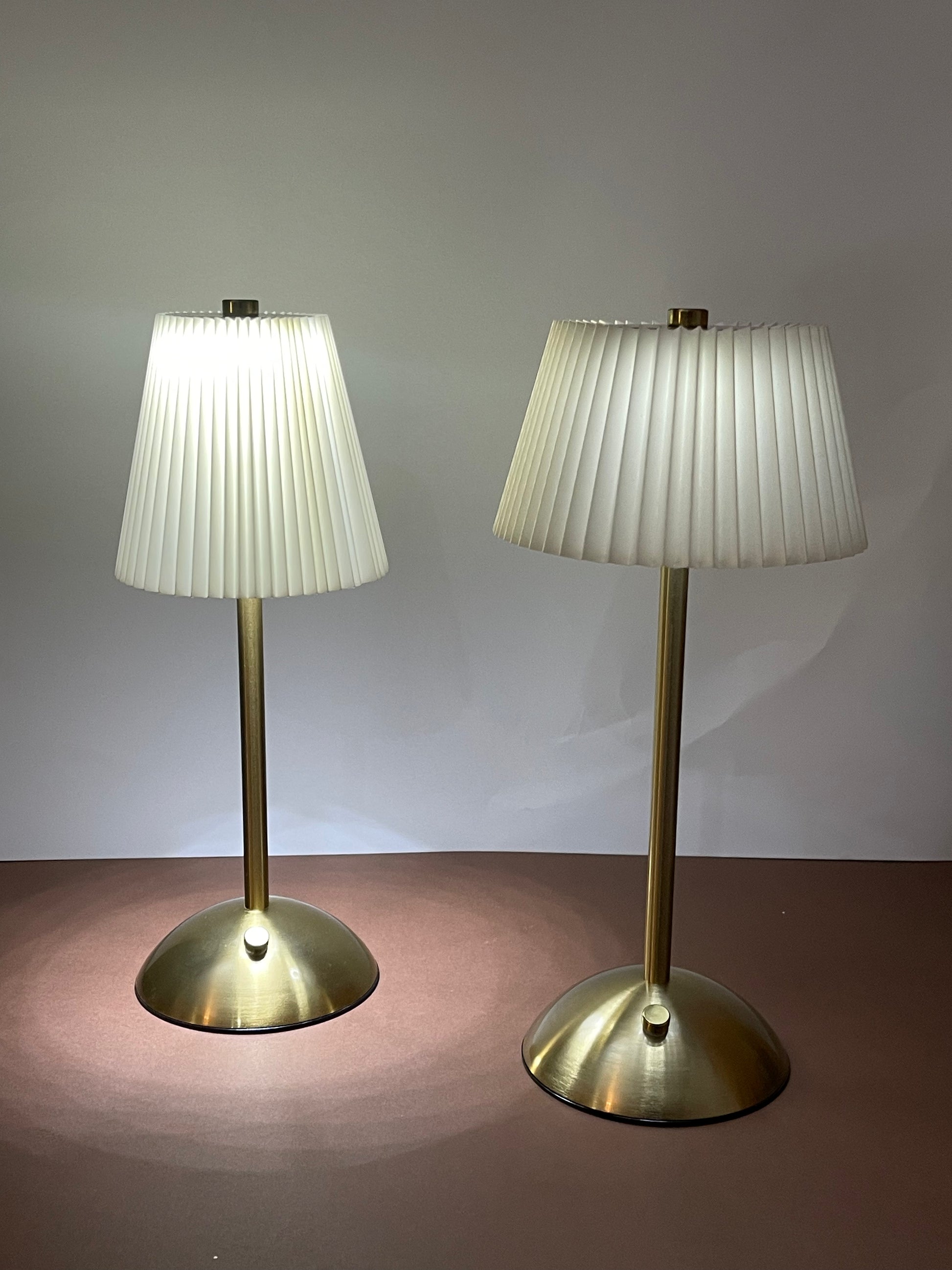Premium white-shaded lamp casting a soft ambient glow in a modern bedroom setting.