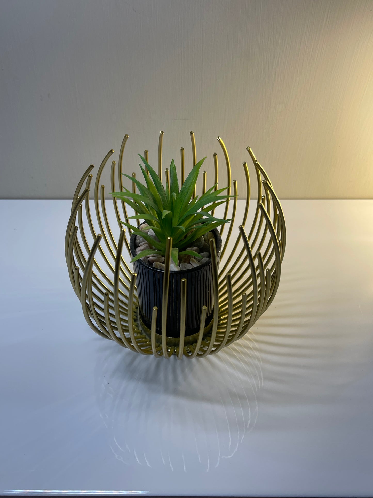 Sleek golden globe planter with removable interior insert.