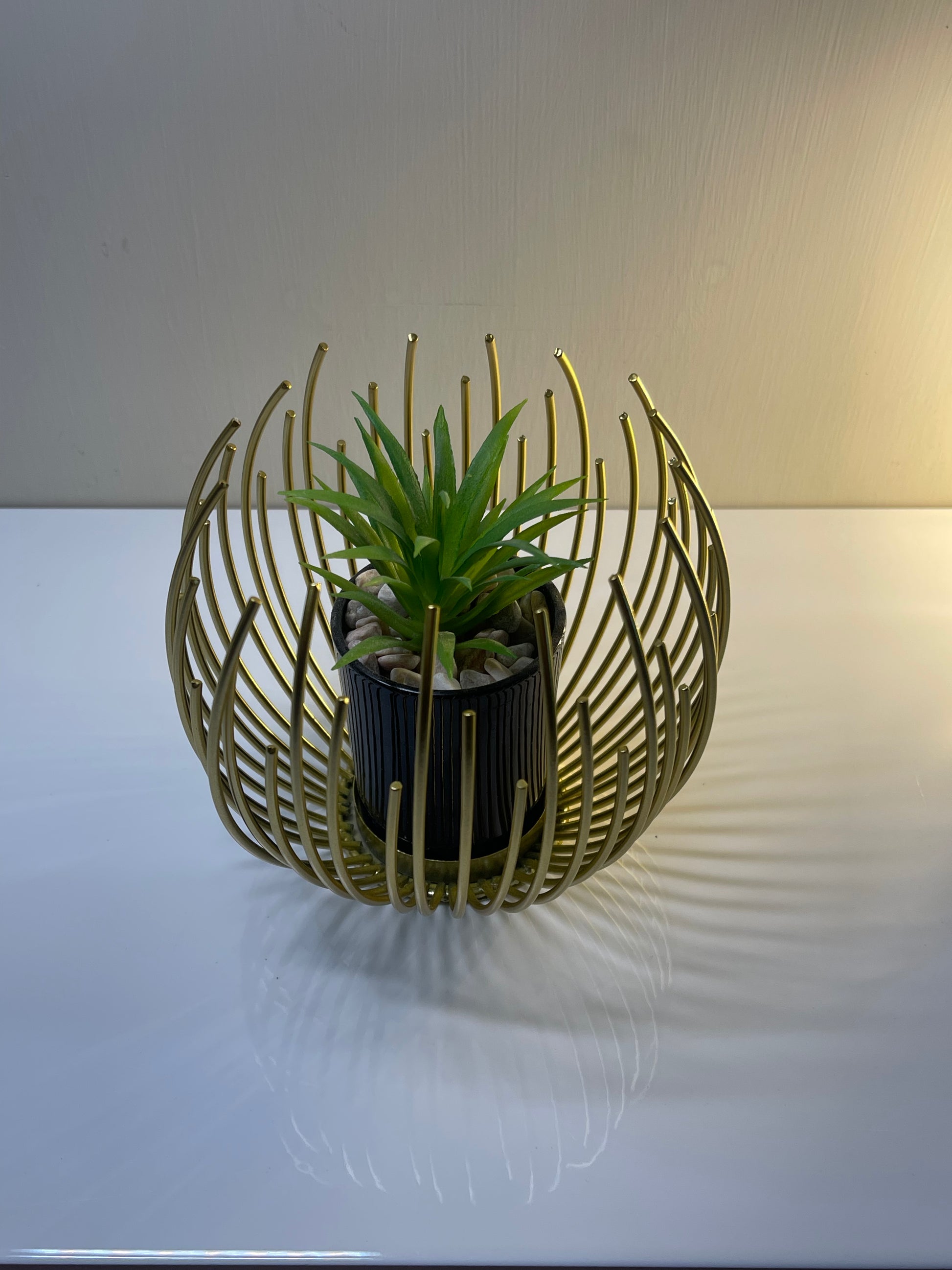 Sleek golden globe planter with removable interior insert.