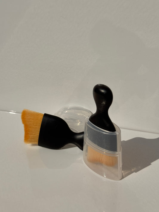 Soft brush in use, cleaning dust from car air vents for a spotless finish.
