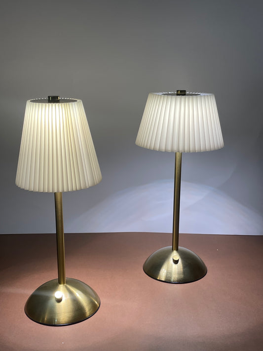 Sophisticated bedside lamp with a timeless white fabric shade and gold-tone base.