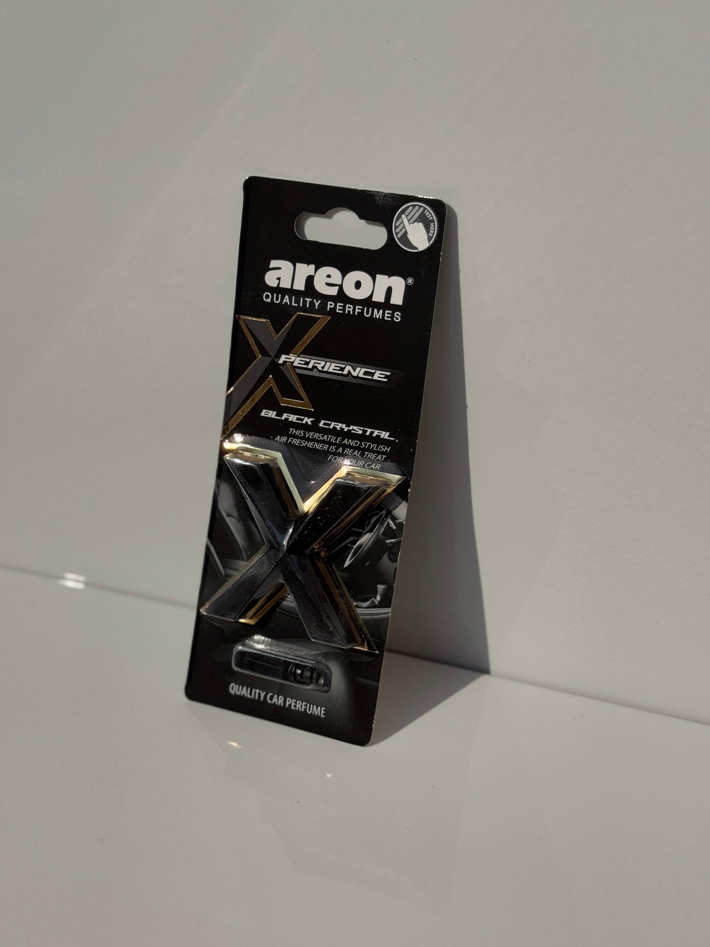 Sophisticated packaging of AREON X-perience Air Freshener Card in 'Black Crystal' scent.